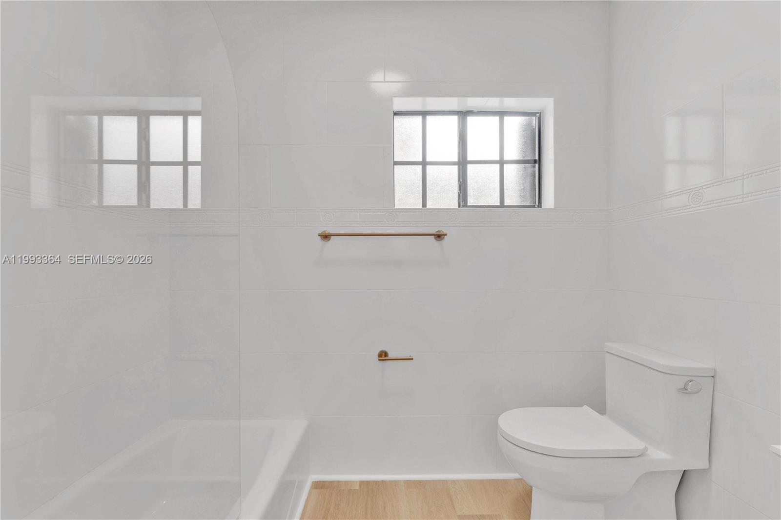 456 Southwest 20th Road, Unit 458 Miami, FL 33129 - Photo 18 of 37 a bathroom with a toilet and a bathtub