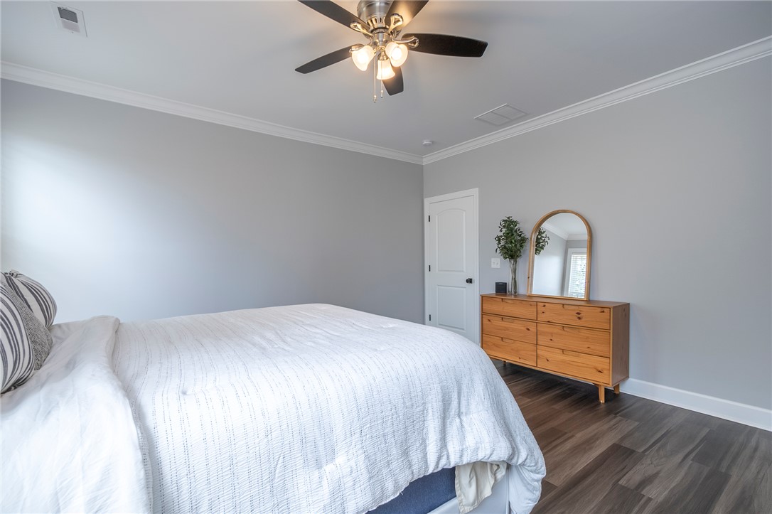 3080 McGee Road Iva, SC 29655 - Photo 31 of 49 Clean lines and wood-look flooring establish a serene atmosphere in this inviting bedroom.