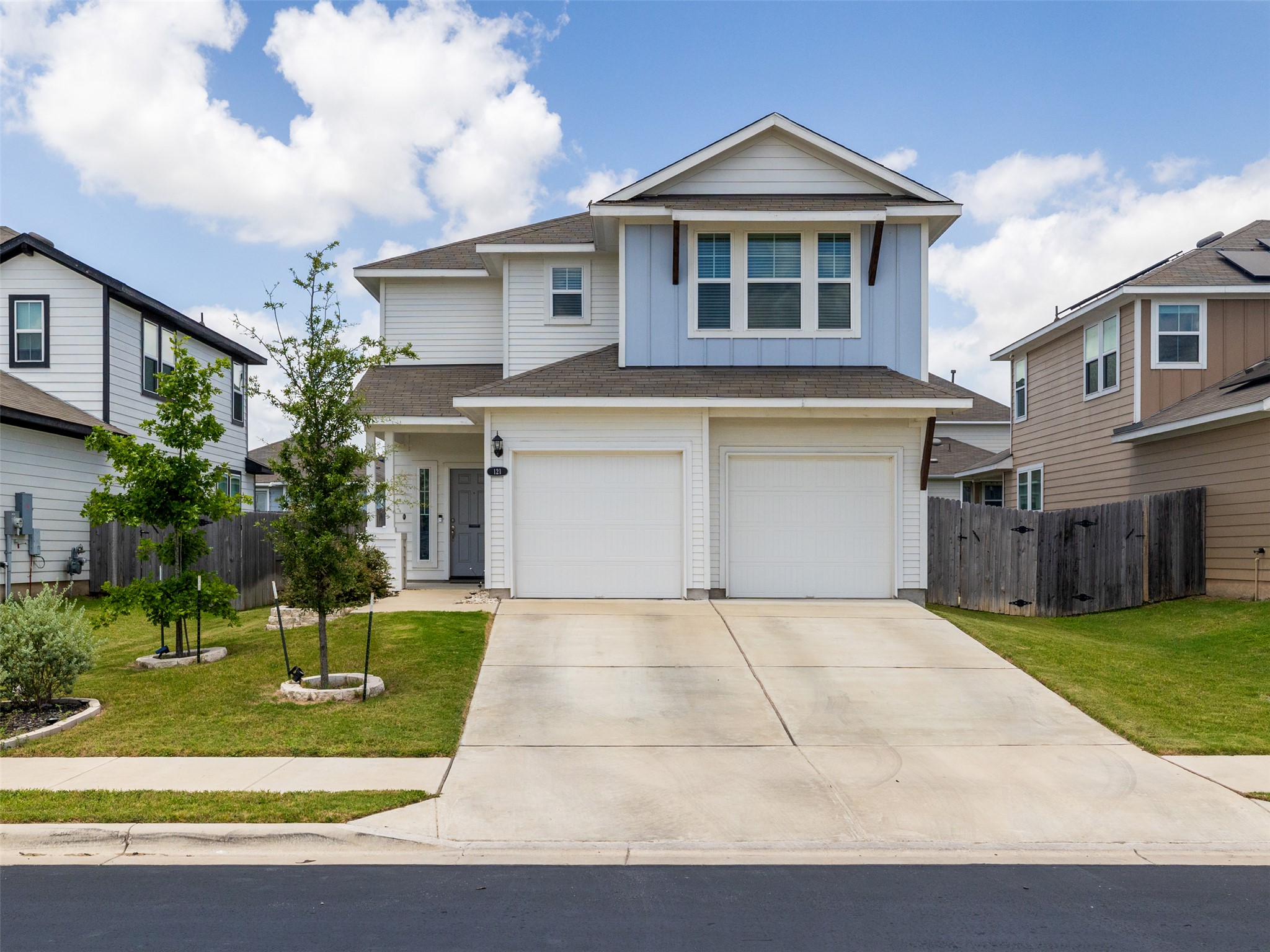 121 Graver Street Georgetown, TX 78626 - Photo 2 of 28 A welcoming facade with a two-car garage offers ample parking and curb appeal.