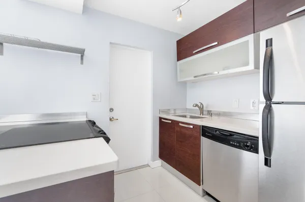 a kitchen with a sink and a refrigerator