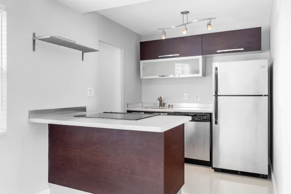 a kitchen with stainless steel appliances a sink and a refrigerator