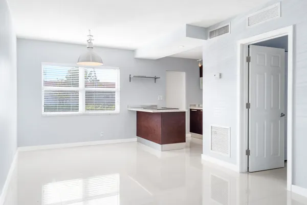 a view of kitchen with windows and cabinet
