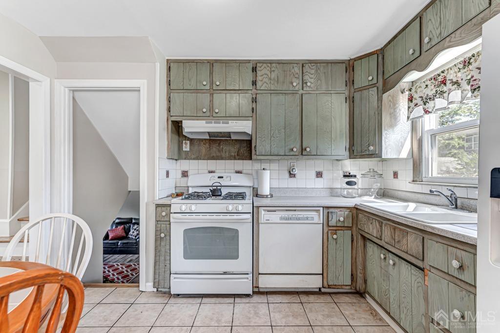 528 Melrose Avenue Middlesex, NJ 08846 - Photo 11 of 40 a kitchen with stainless steel appliances granite countertop a sink a stove a refrigerator and island with wooden cabinets