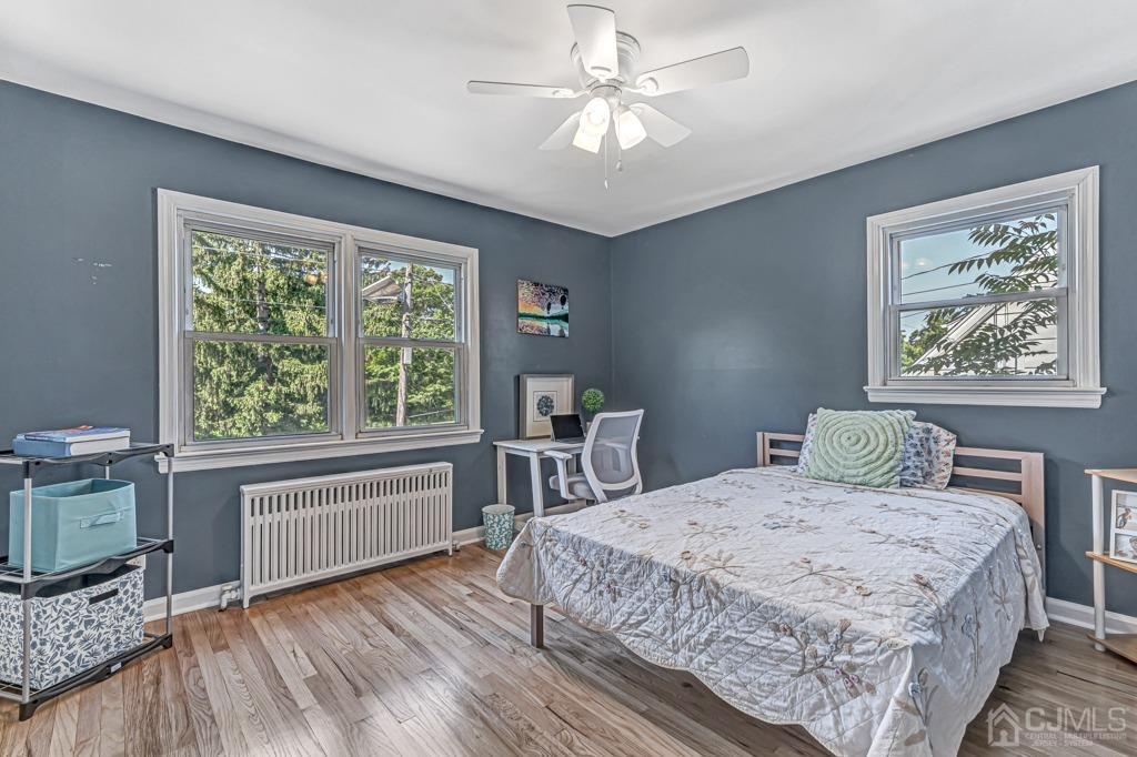528 Melrose Avenue Middlesex, NJ 08846 - Photo 13 of 40 a bedroom with a large bed a chandelier and windows