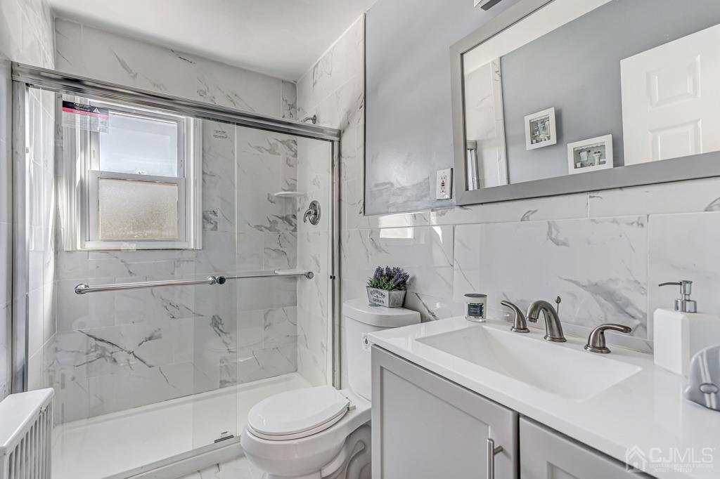 528 Melrose Avenue Middlesex, NJ 08846 - Photo 15 of 40 a bathroom with a sink vanity granite toilet and shower