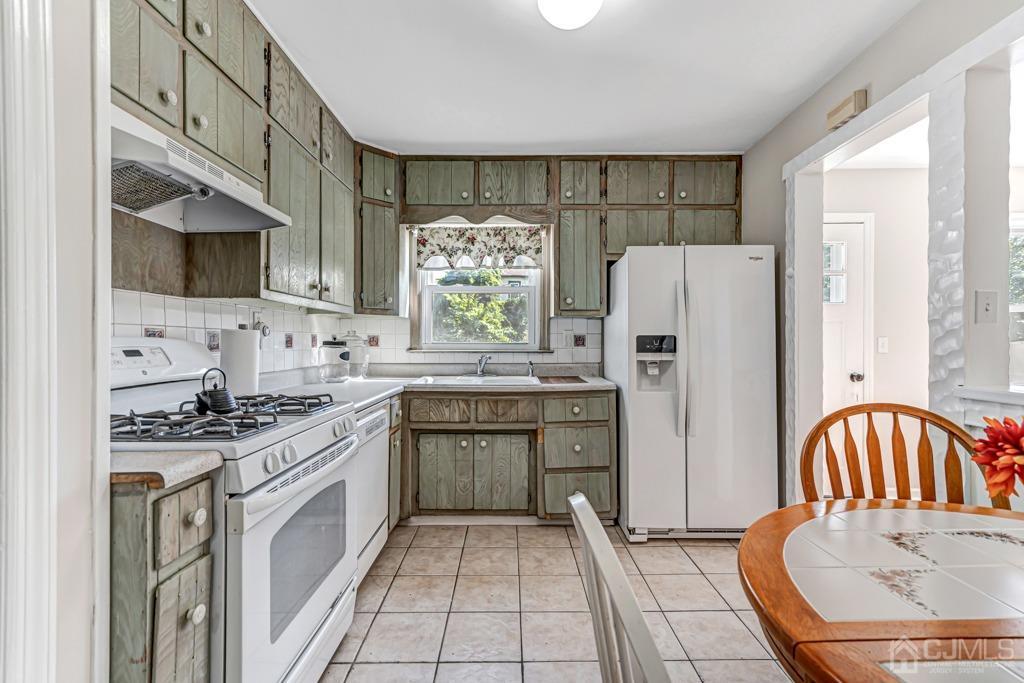 528 Melrose Avenue Middlesex, NJ 08846 - Photo 4 of 40 a kitchen with stainless steel appliances granite countertop a sink a stove a refrigerator cabinets and a window