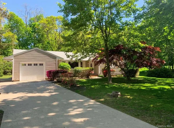 a house view with a sitting space and garden