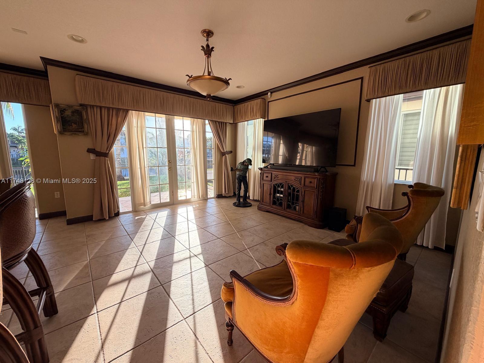 1065 Southwest 150th Place Miami, FL 33194 - Photo 11 of 18 a living room with furniture and a flat screen tv