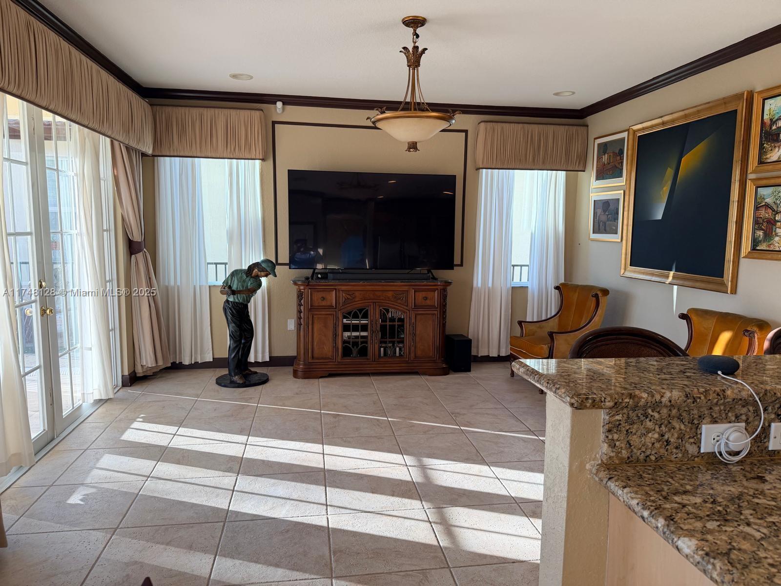 1065 Southwest 150th Place Miami, FL 33194 - Photo 12 of 18 a living room with furniture and a flat screen tv