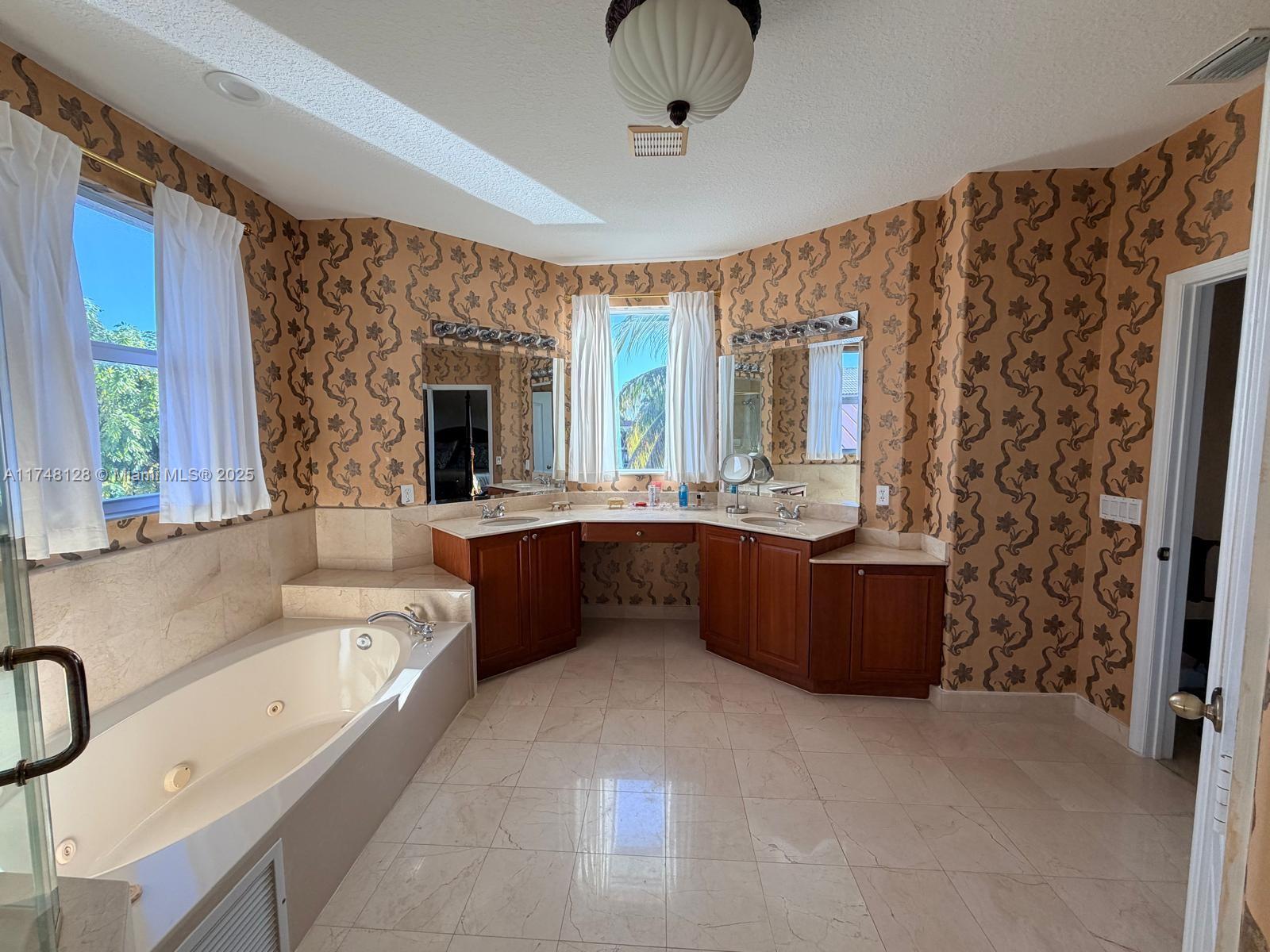 1065 Southwest 150th Place Miami, FL 33194 - Photo 14 of 18 a bathroom with a tub sink and mirror