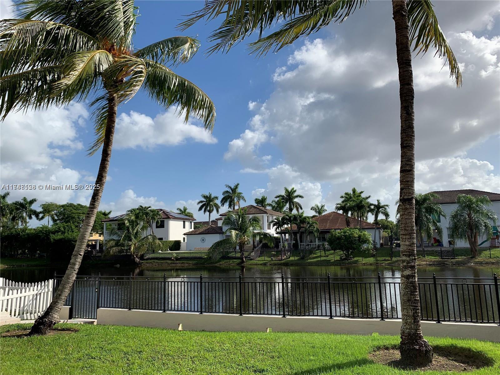 1065 Southwest 150th Place Miami, FL 33194 - Photo 16 of 18 a lake view with palm trees