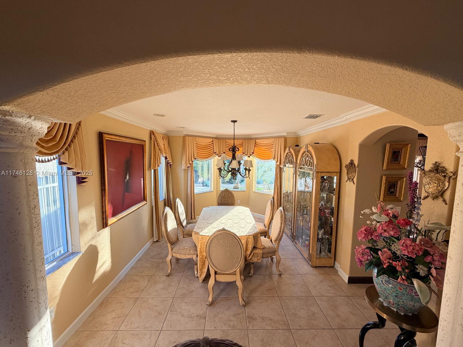 1065 Southwest 150th Place Miami, FL 33194 - Photo 8 of 18 a dining room with furniture and window