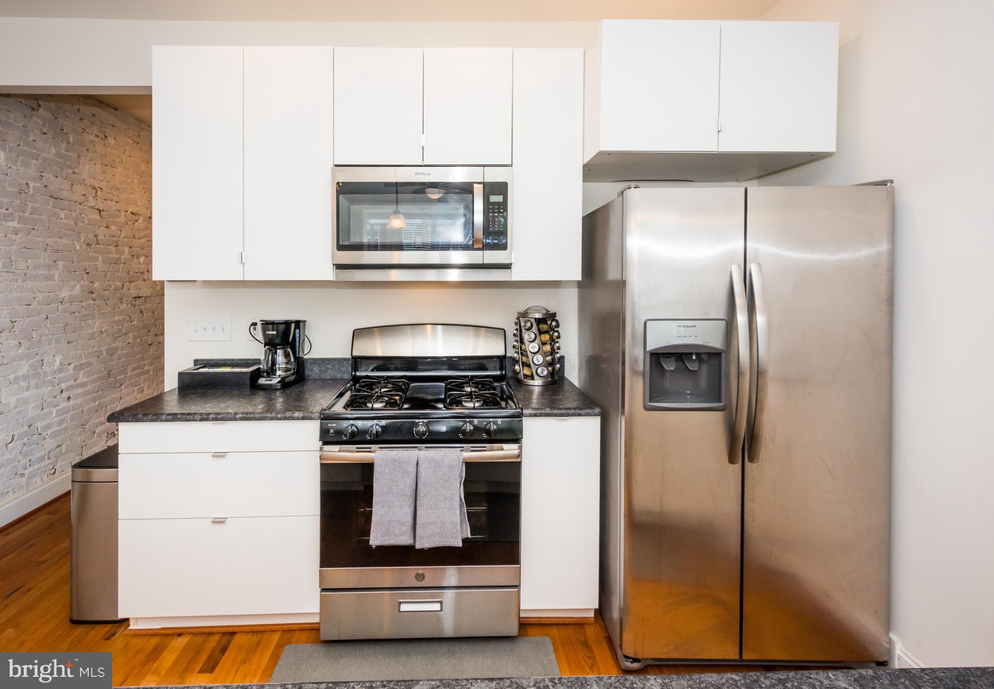 600 South Linwood Avenue, Unit A Baltimore, MD 21224 - Photo 12 of 33 a kitchen with a stove and a refrigerator