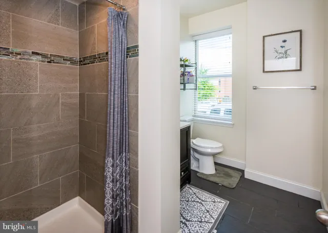 a bathroom with a toilet and a shower