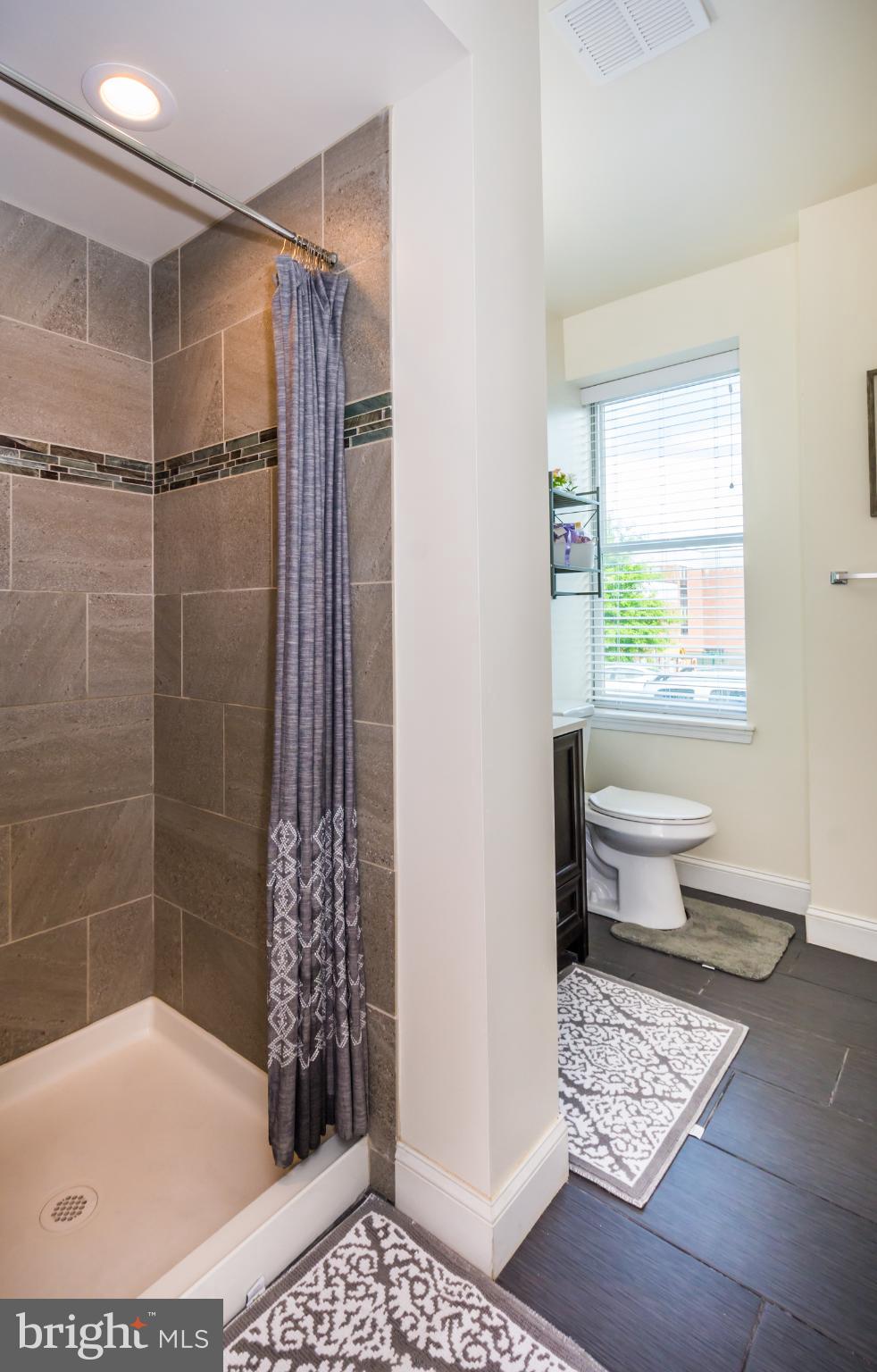 600 South Linwood Avenue, Unit A Baltimore, MD 21224 - Photo 14 of 33 a bathroom with a bathtub and a shower