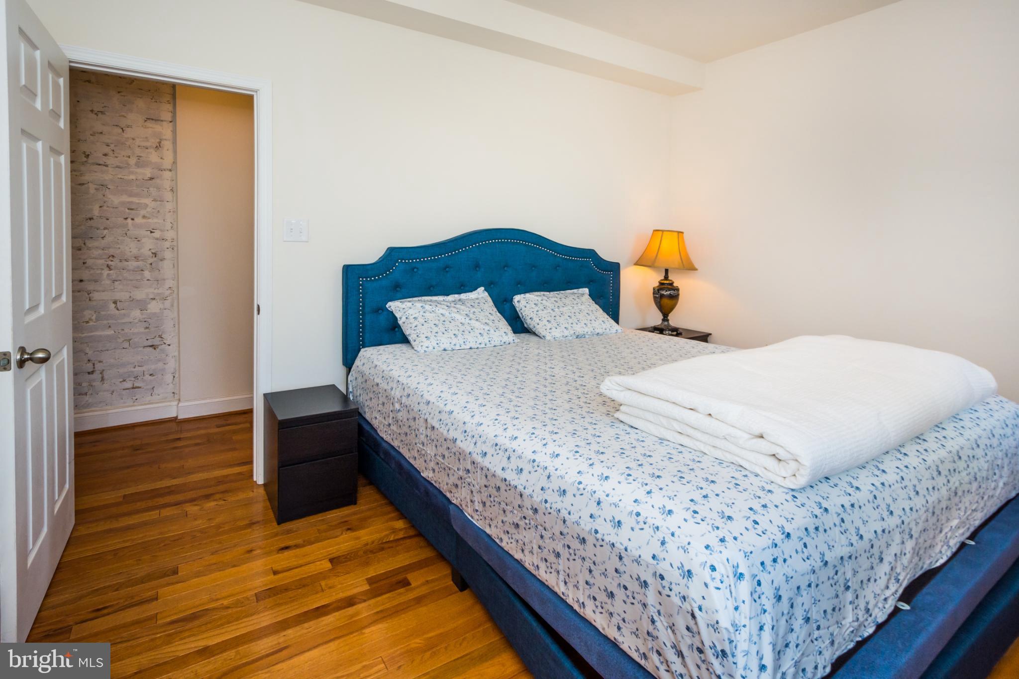 600 South Linwood Avenue, Unit A Baltimore, MD 21224 - Photo 17 of 33 a bedroom with a bed and wooden floor