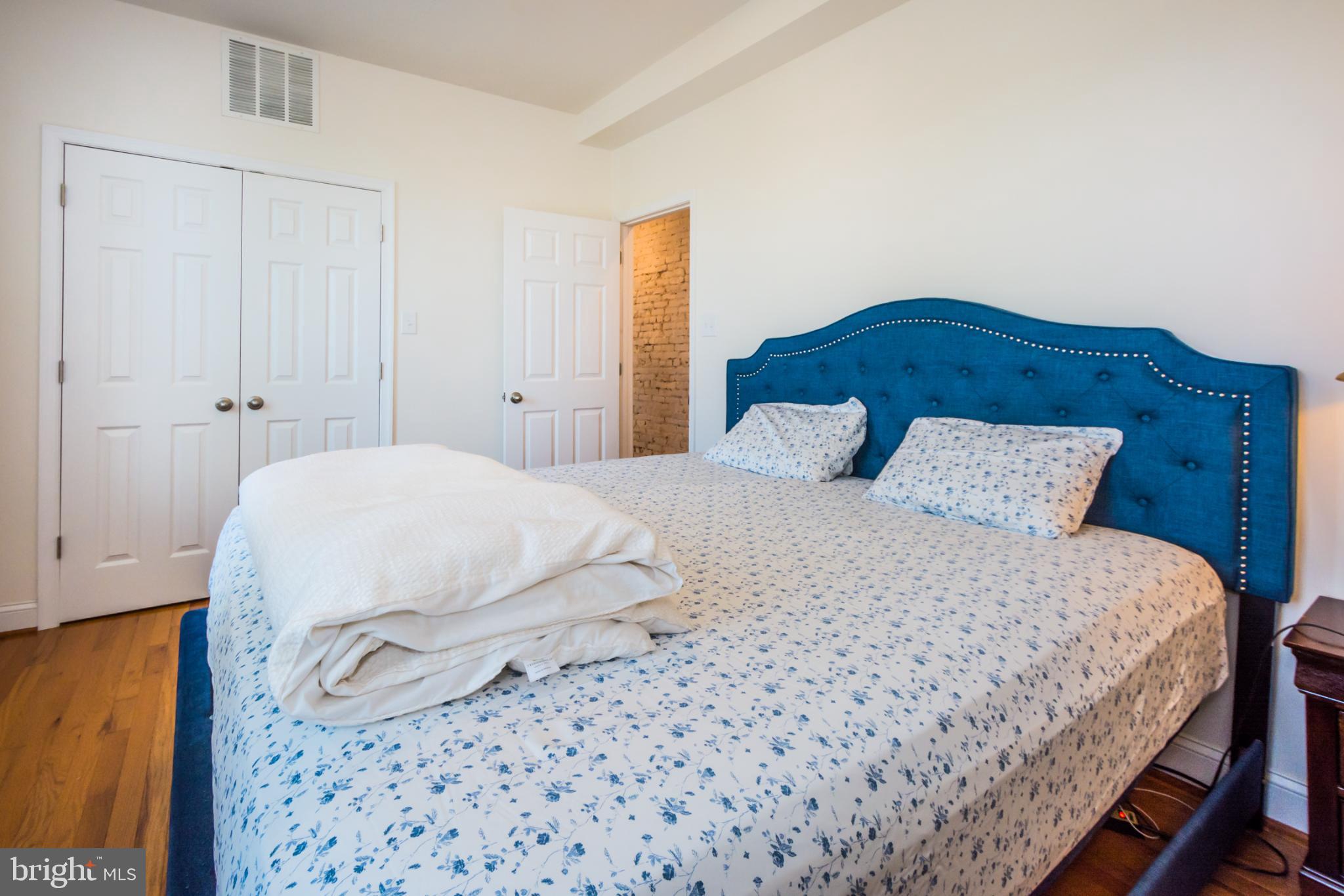 600 South Linwood Avenue, Unit A Baltimore, MD 21224 - Photo 18 of 33 a bedroom with a bed and a night stand