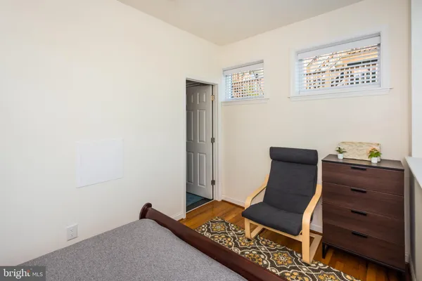 a living room with furniture and a baby crib