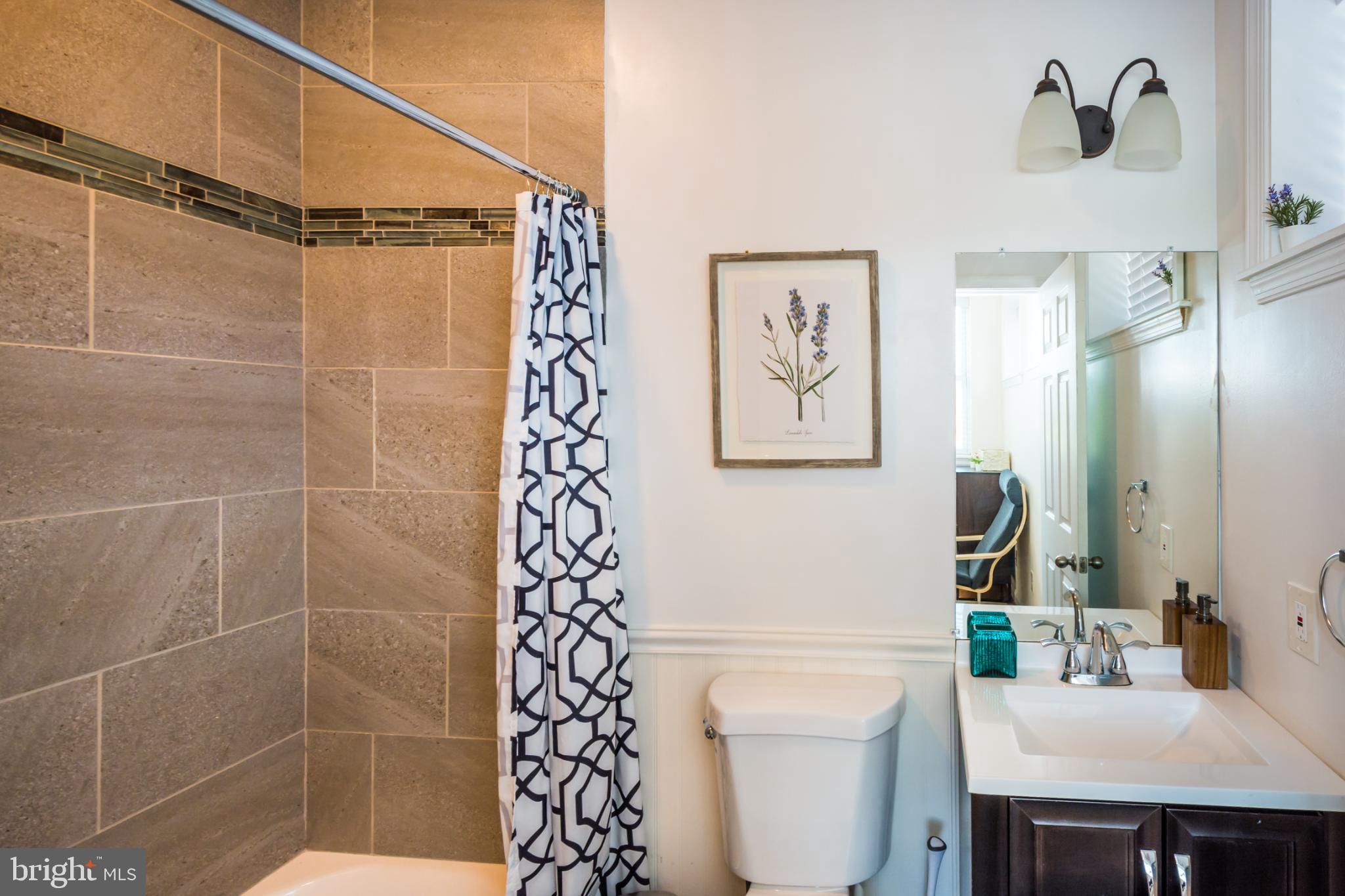 600 South Linwood Avenue, Unit A Baltimore, MD 21224 - Photo 23 of 33 a bathroom with a shower a sink and a toilet