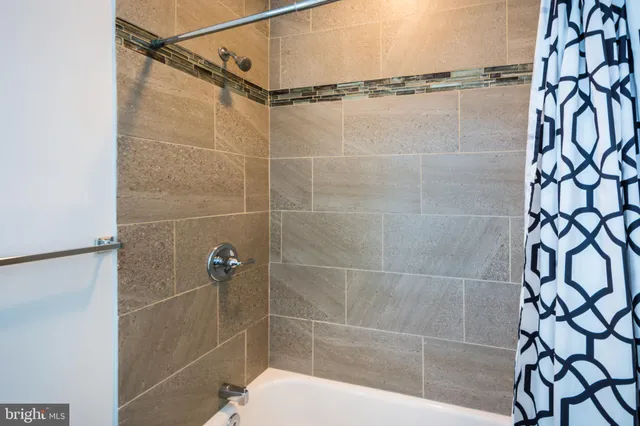 a bathroom with a shower and a shower