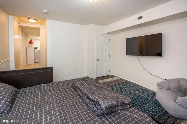 a bedroom with a bed and a flat screen tv