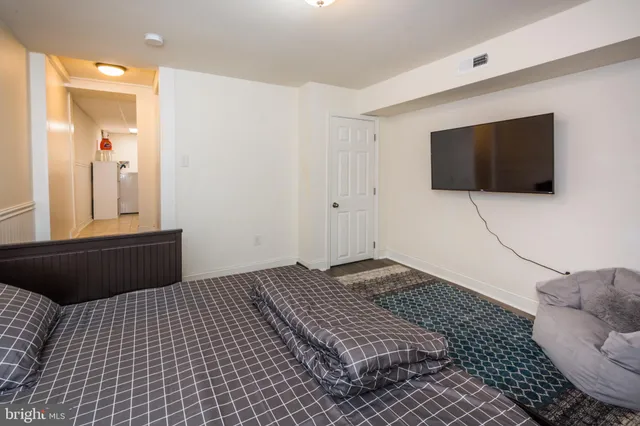 a bedroom with a bed and a flat screen tv