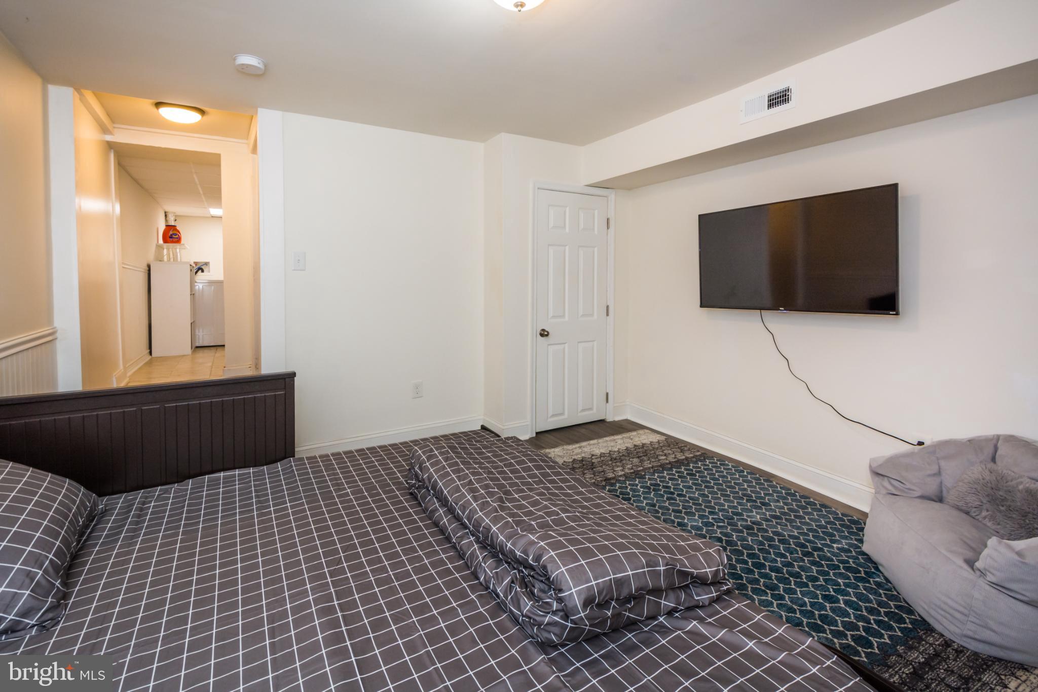 600 South Linwood Avenue, Unit A Baltimore, MD 21224 - Photo 26 of 33 a bedroom with a bed and a flat screen tv