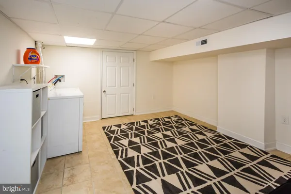 a storage & utility room with a sink