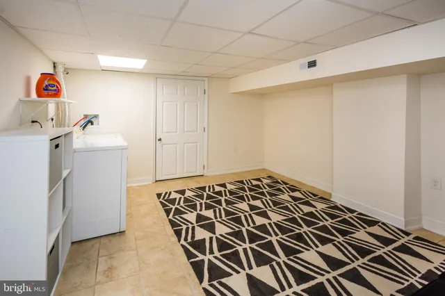 a storage & utility room with a sink
