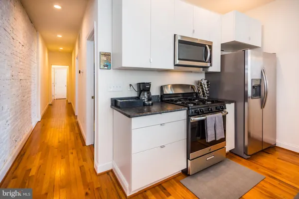 a kitchen with a sink and steel appliances