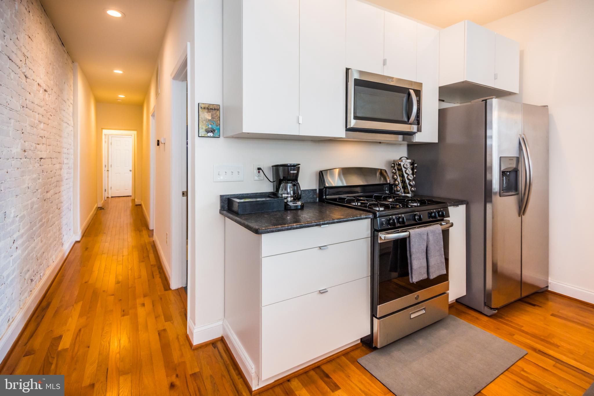 600 South Linwood Avenue, Unit A Baltimore, MD 21224 - Photo 9 of 33 a kitchen with a sink and steel appliances