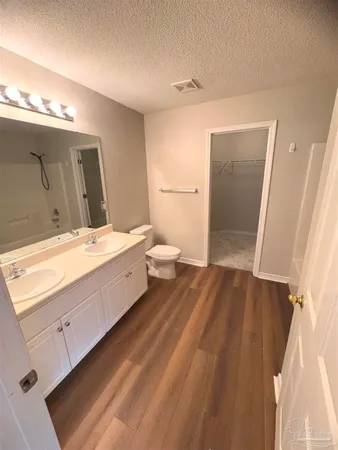 a spacious bathroom with a double vanity sink and a mirror