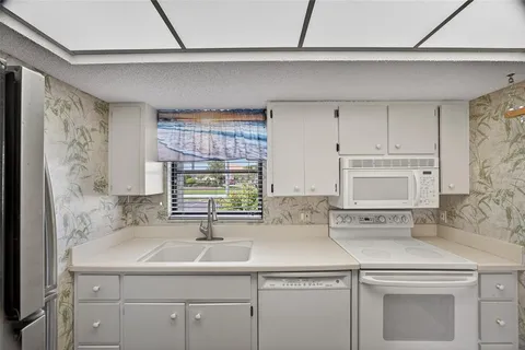 a kitchen with a sink and cabinets