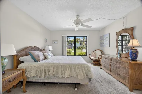a bedroom with a bed window and dresser
