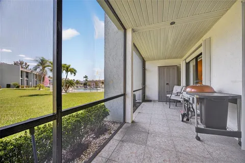 a view of a porch with furniture and garden