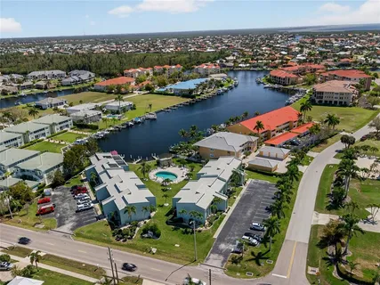an aerial view of lake and residential houses with outdoor space