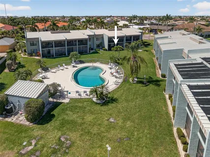 a swimming pool with outdoor seating and yard