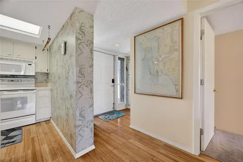 a view of a kitchen with wooden floor and electronic appliances