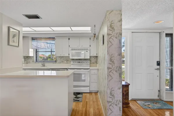 a kitchen with stainless steel appliances granite countertop a sink and a refrigerator