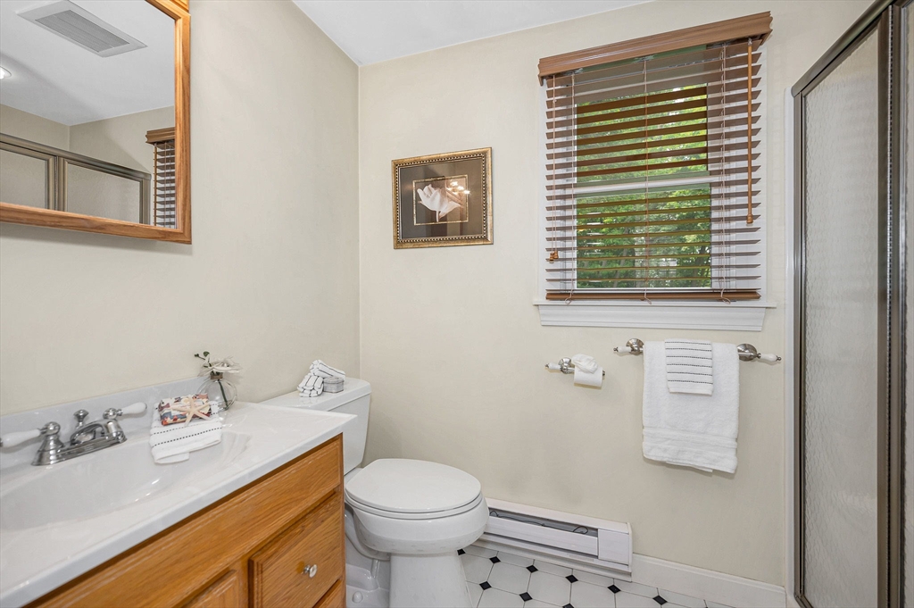 15 Eustis Avenue Wakefield, MA 01880 - Photo 22 of 42 a bathroom with a sink a toilet and shower curtain