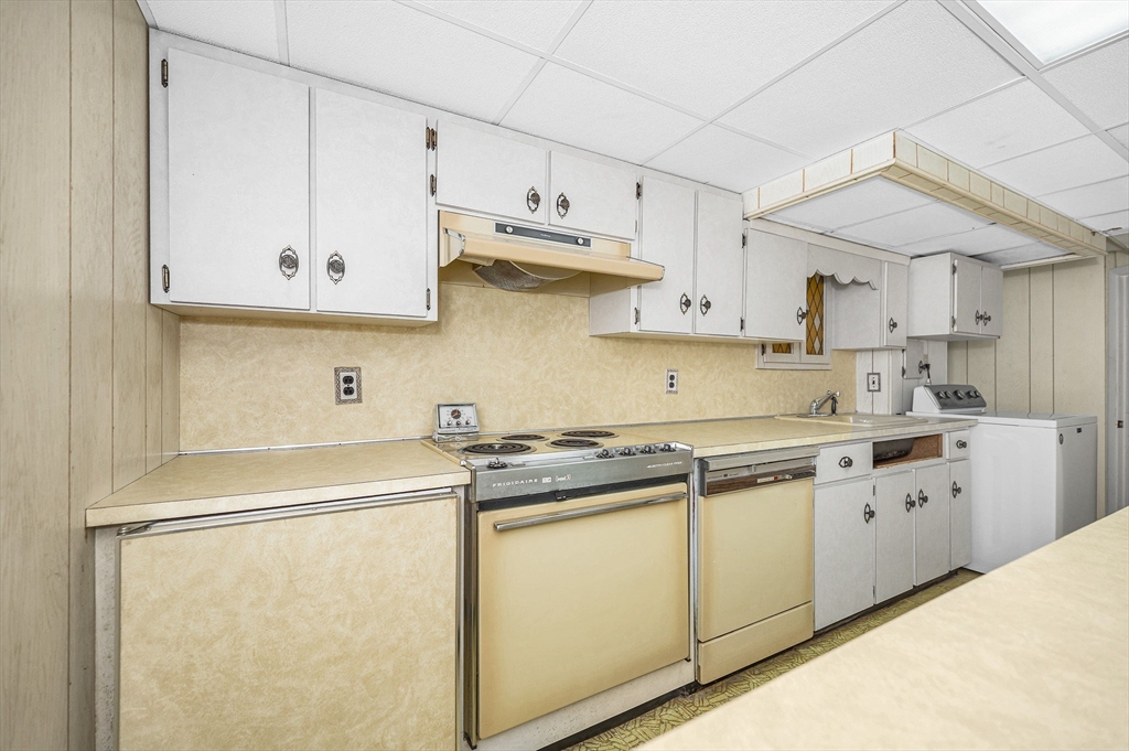 15 Eustis Avenue Wakefield, MA 01880 - Photo 29 of 42 a kitchen with white cabinets and white appliances