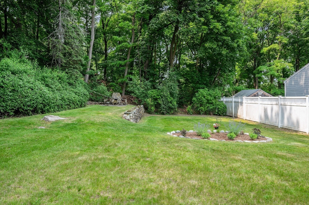 15 Eustis Avenue Wakefield, MA 01880 - Photo 34 of 42 a view of a white house with a big yard and potted plants