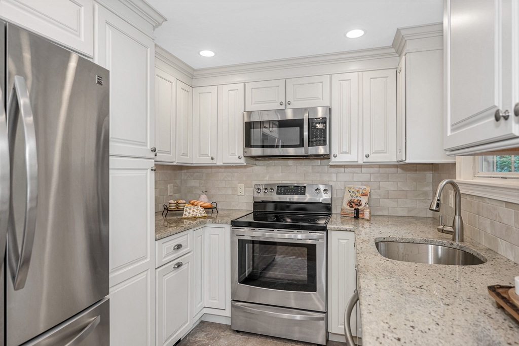 15 Eustis Avenue Wakefield, MA 01880 - Photo 8 of 42 a kitchen with refrigerator a microwave a sink and cabinets