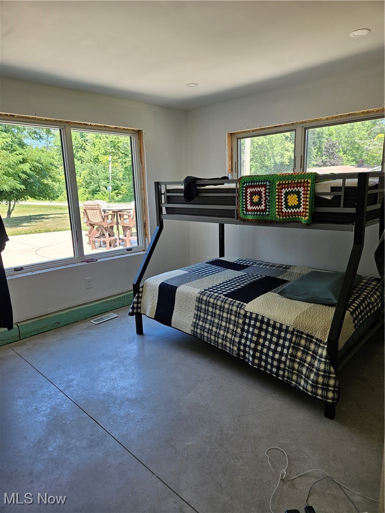 1180 North County Line Road Geneva, OH 44041 - Photo 24 of 33 Bedroom with multiple windows and finished concrete floors