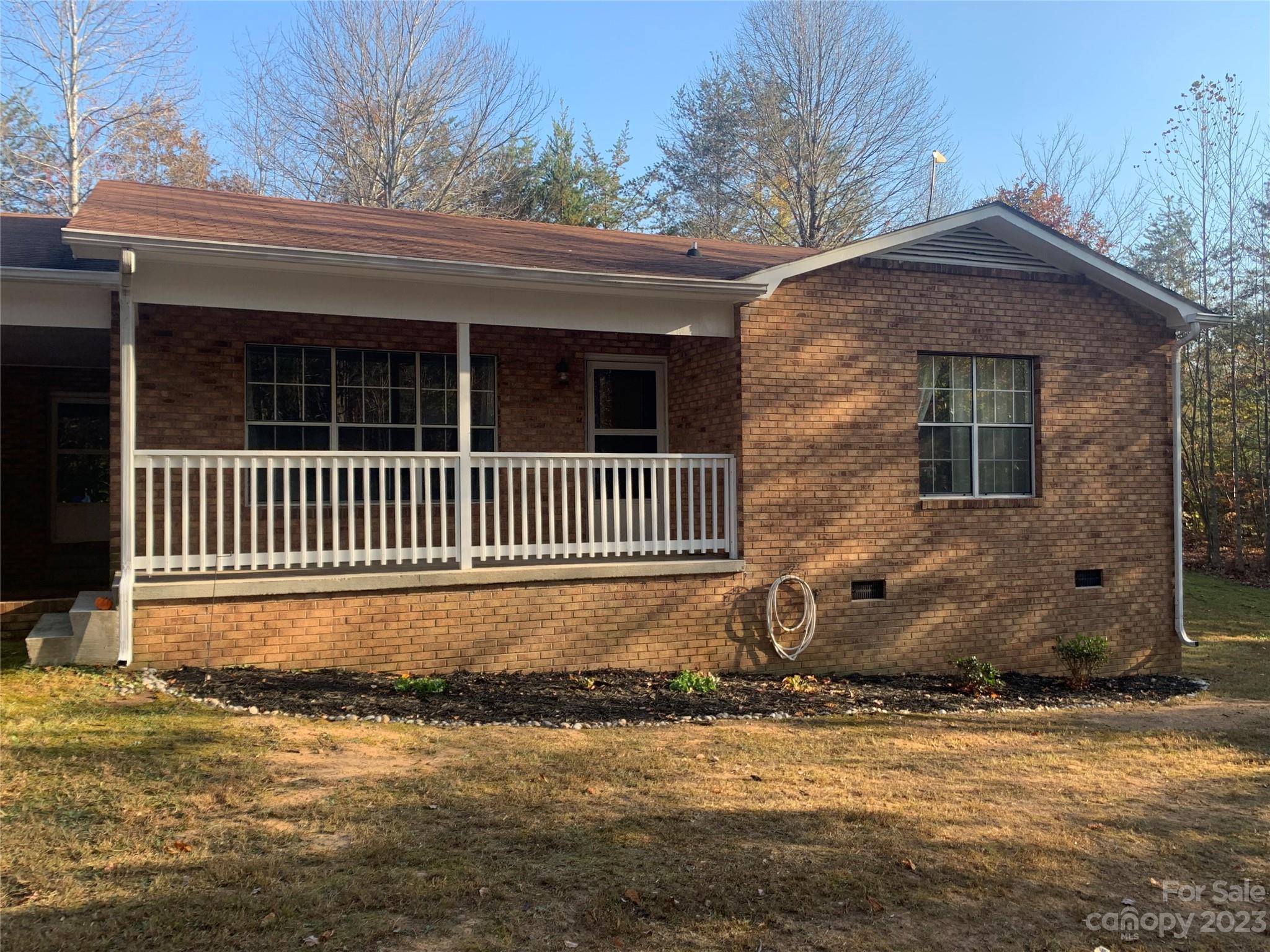 100 Owl Hollow Road Mill Spring, NC 28756 - Photo 1 of 29 a front view of a house with a yard
