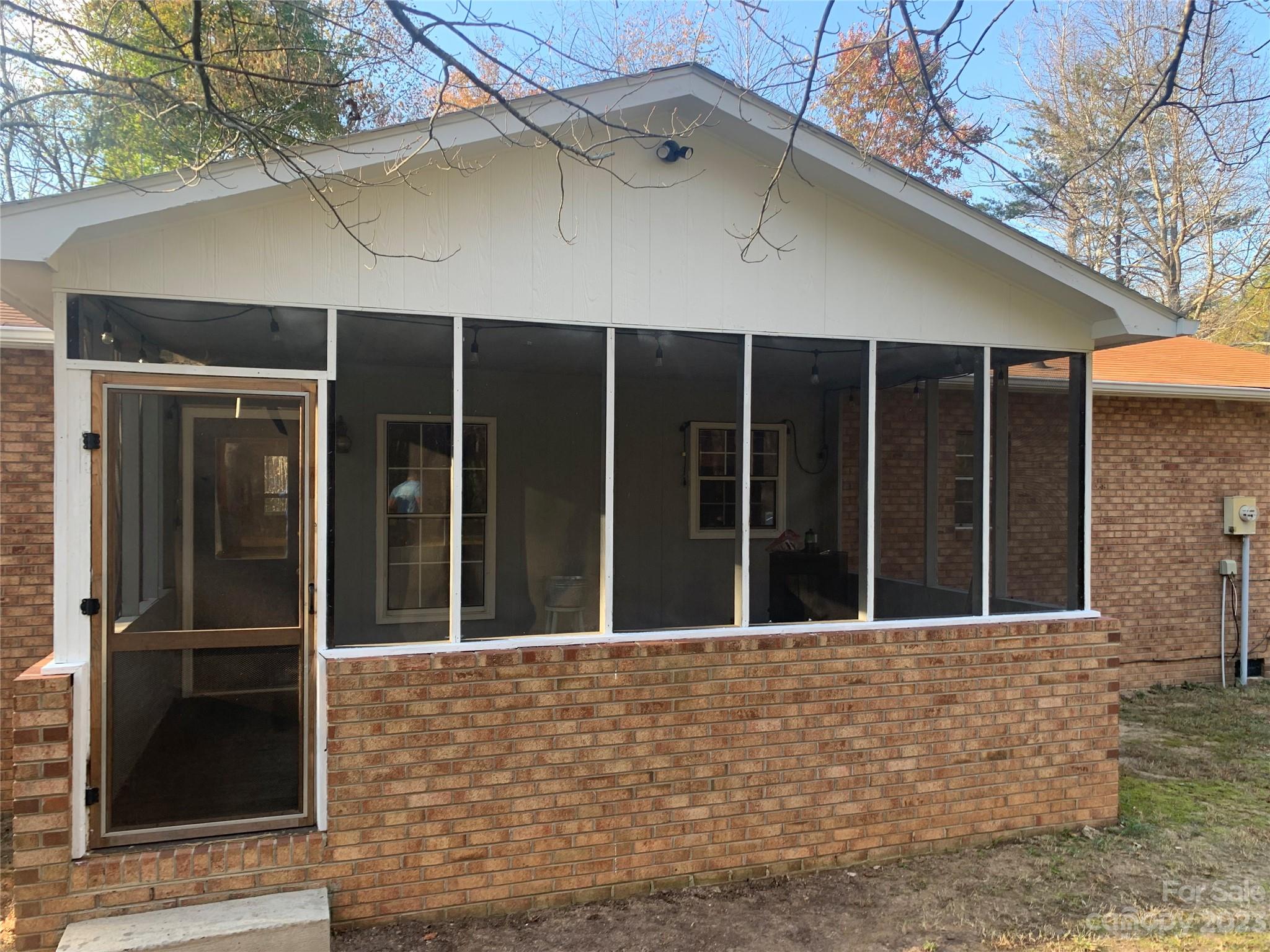 100 Owl Hollow Road Mill Spring, NC 28756 - Photo 5 of 29 a view of a brick house with a large window