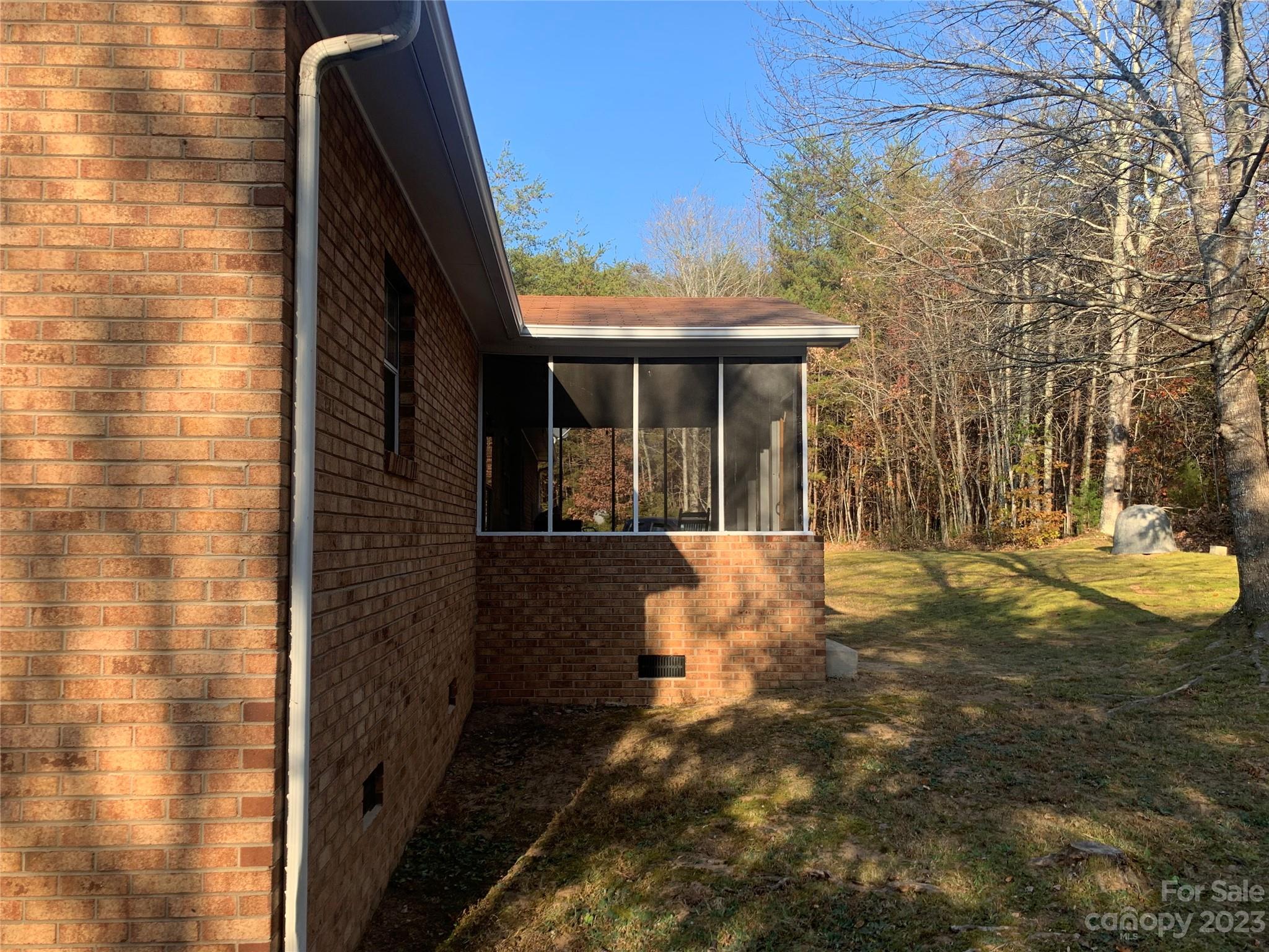 100 Owl Hollow Road Mill Spring, NC 28756 - Photo 6 of 29 a view of a house with backyard and sitting area
