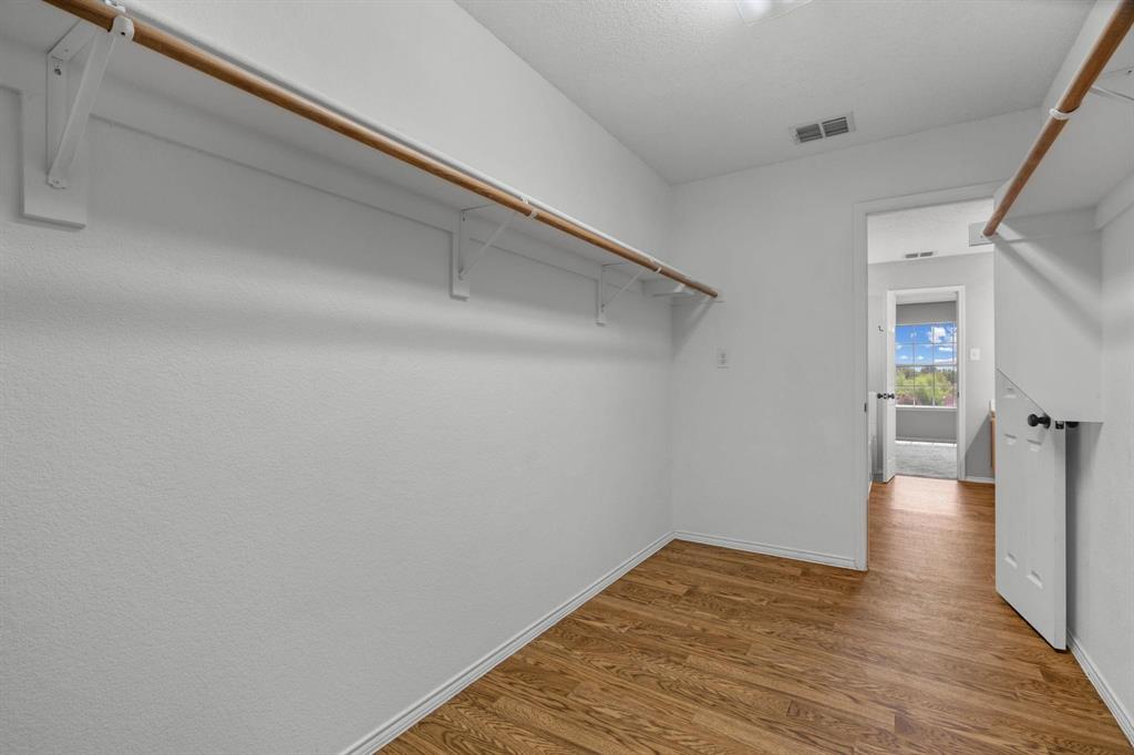 10618 Newcastleton Lane Rowlett, TX 75089 - Photo 10 of 13 a view of a hallway with wooden floor