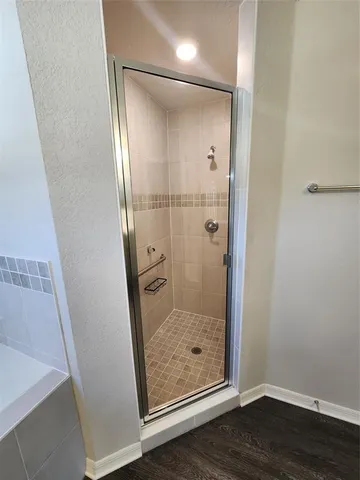a bathroom with a glass shower door