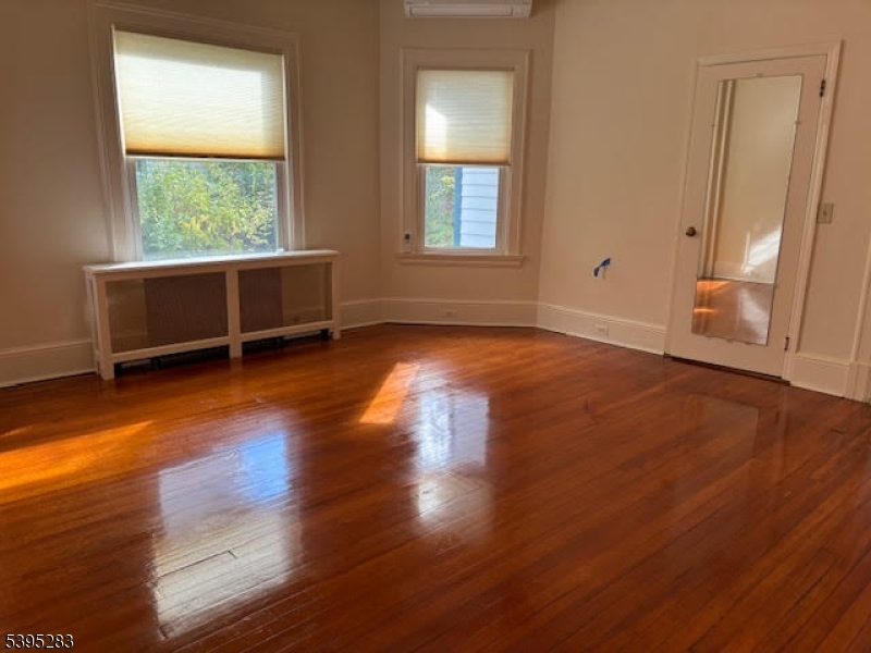 252 Highwood Avenue Ridgewood, NJ 07450 - Photo 15 of 20 an empty room with wooden floor and windows